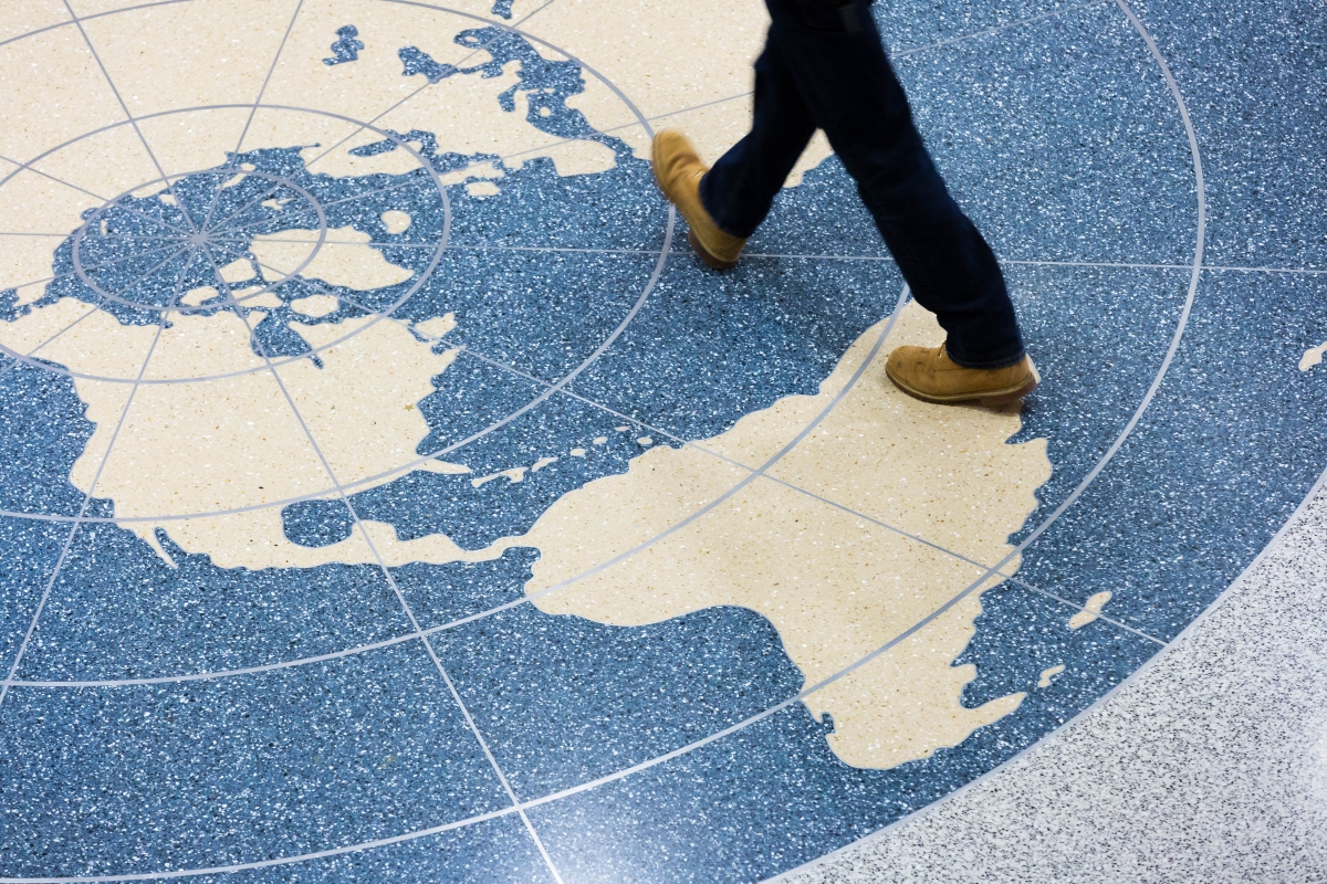 Student Walking Across Global on Duques Floor